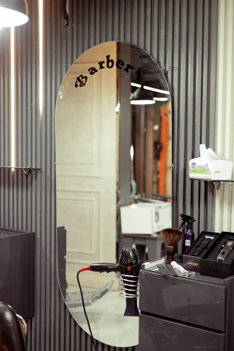A barber's station and mirror, mid-shift