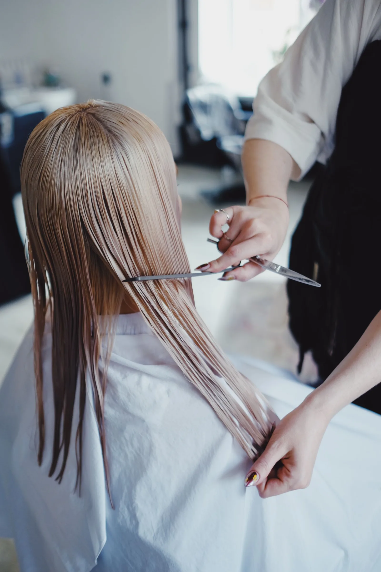 A stylist finishing a client's cut