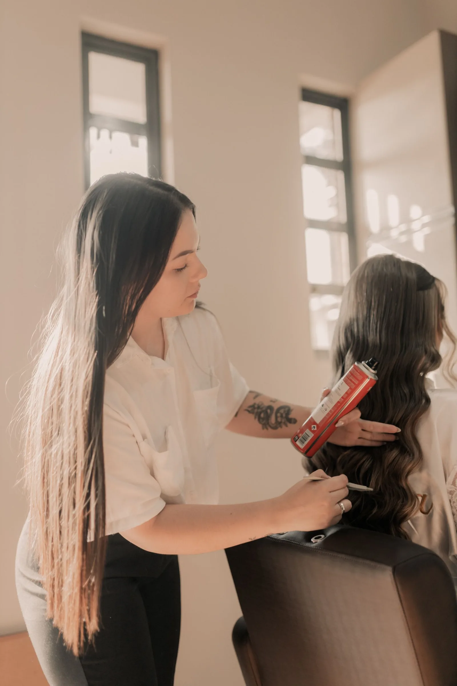 Hair stylist applying colour to a client in a salon