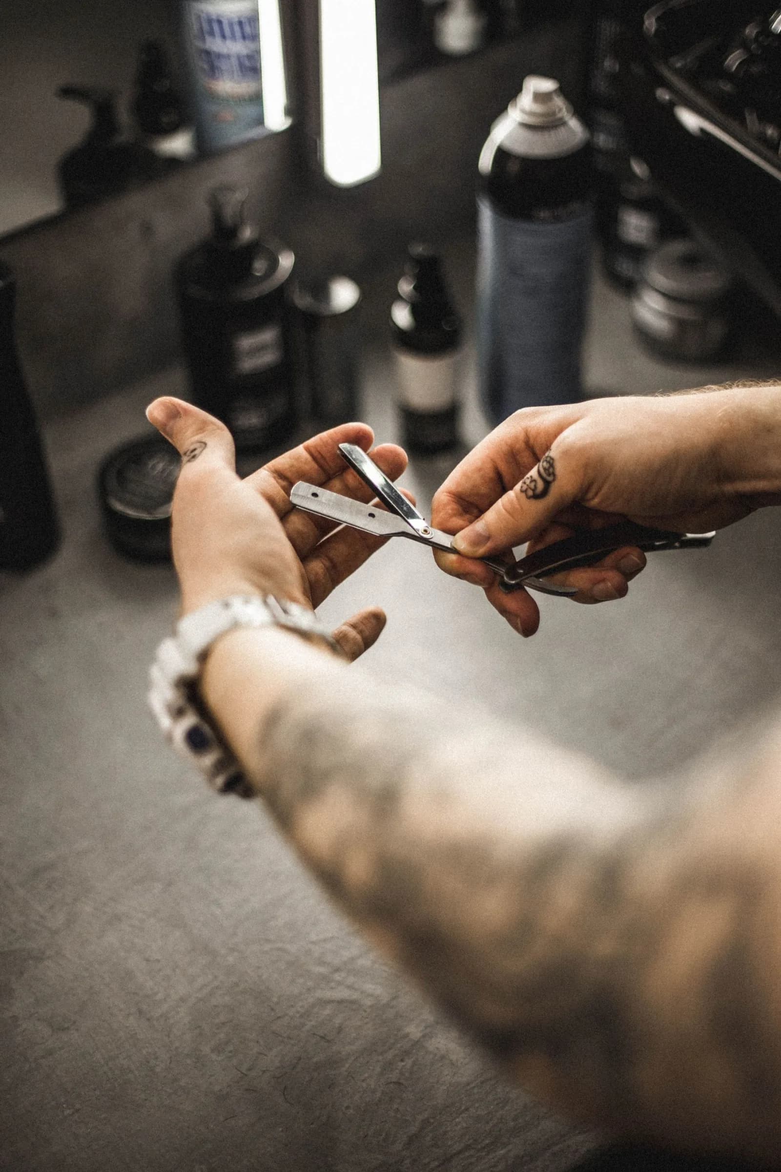 Barber cutting a client's hair with clippers