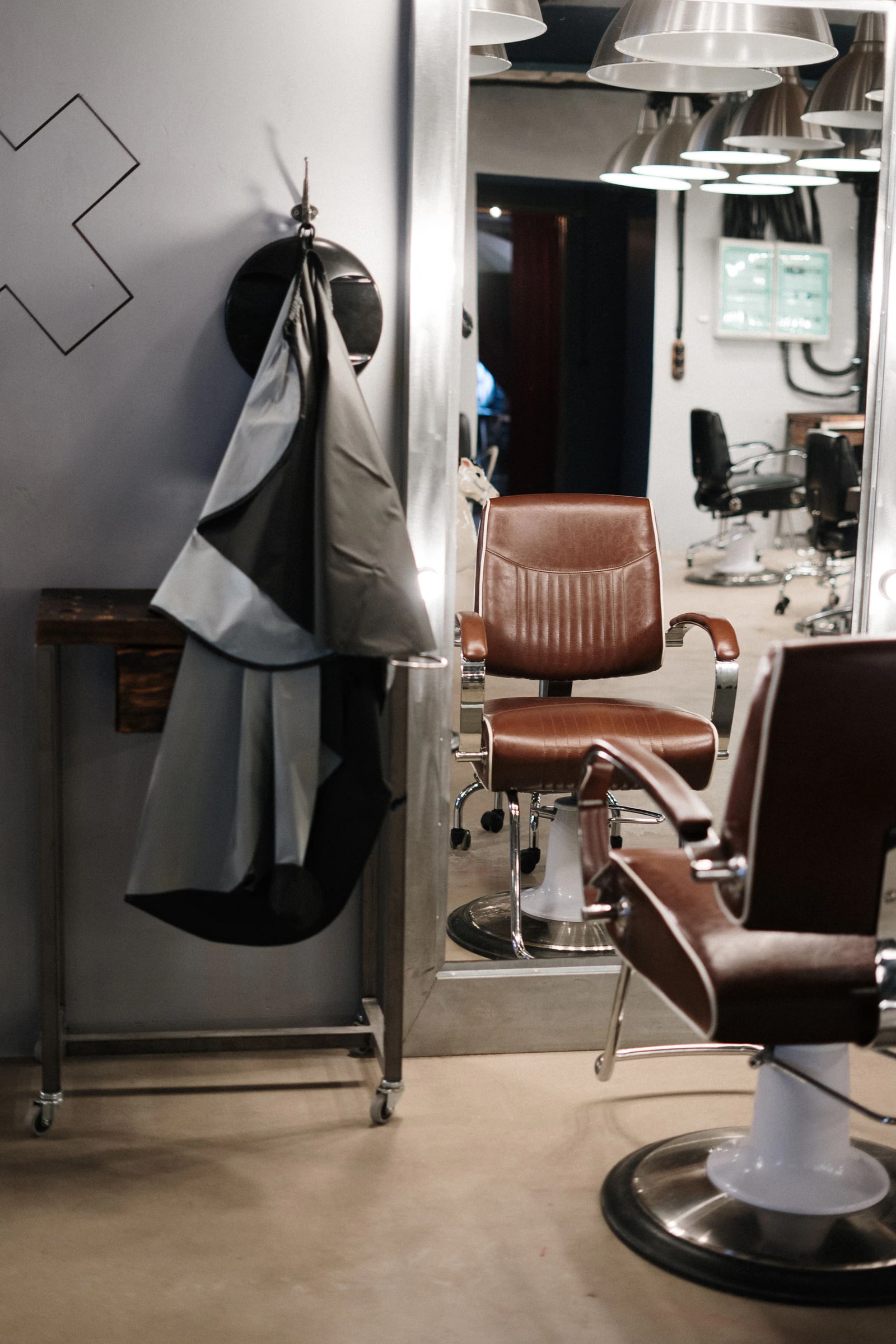 Two leather barber chairs waiting in a quiet shop