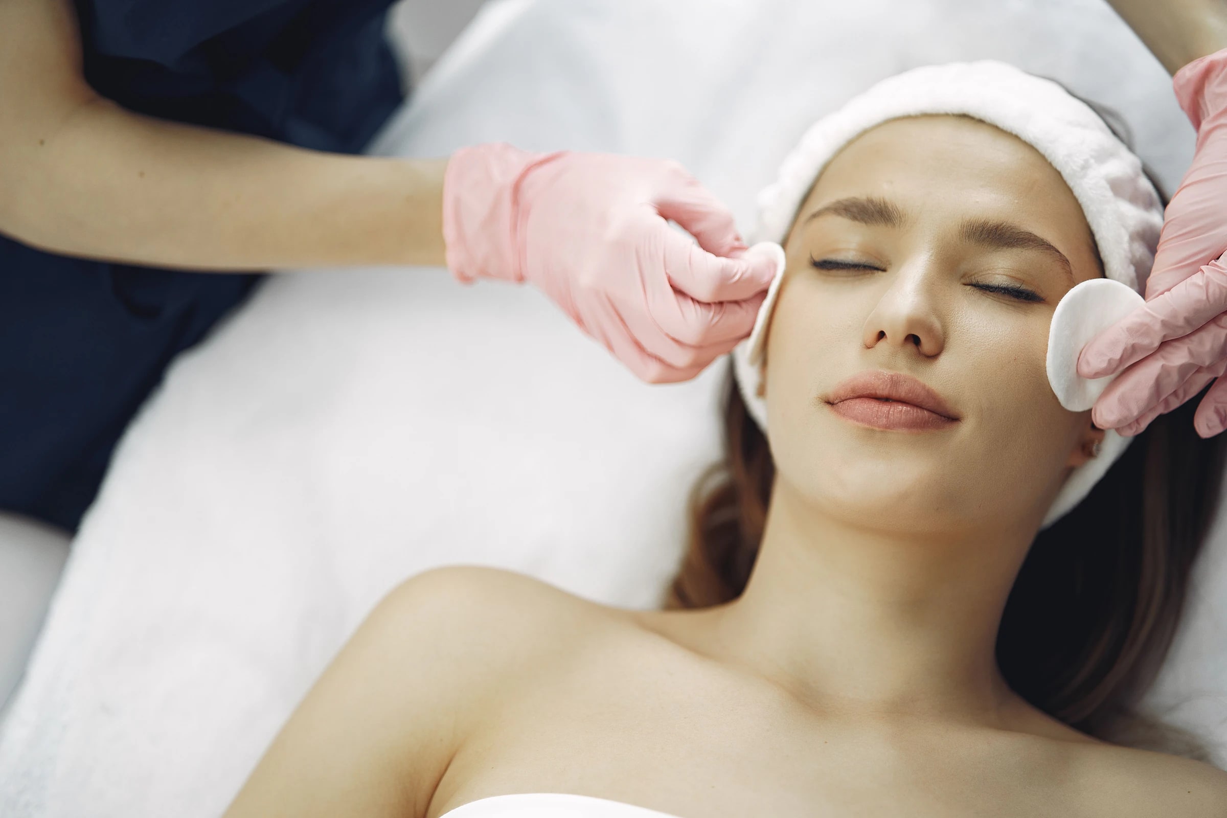 A client relaxing through a facial, eyes closed