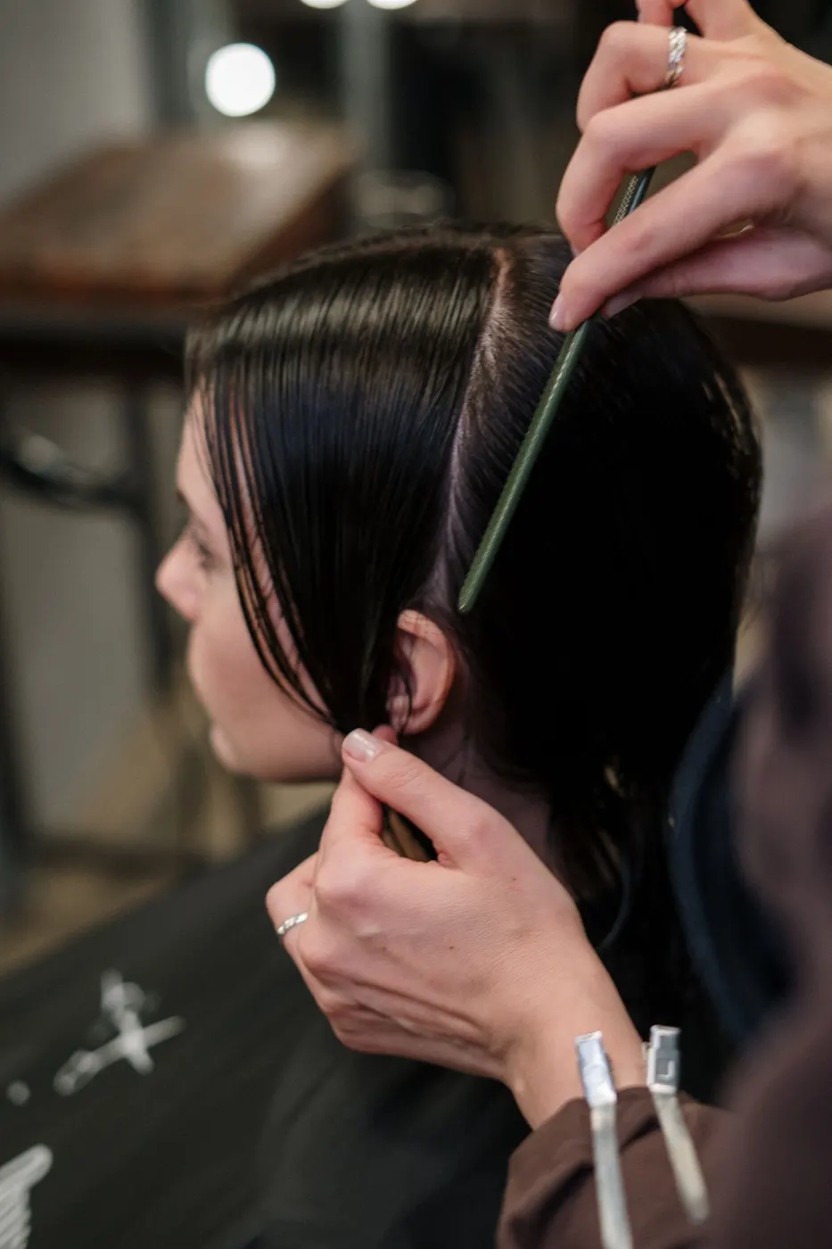 A stylist sectioning a client's hair