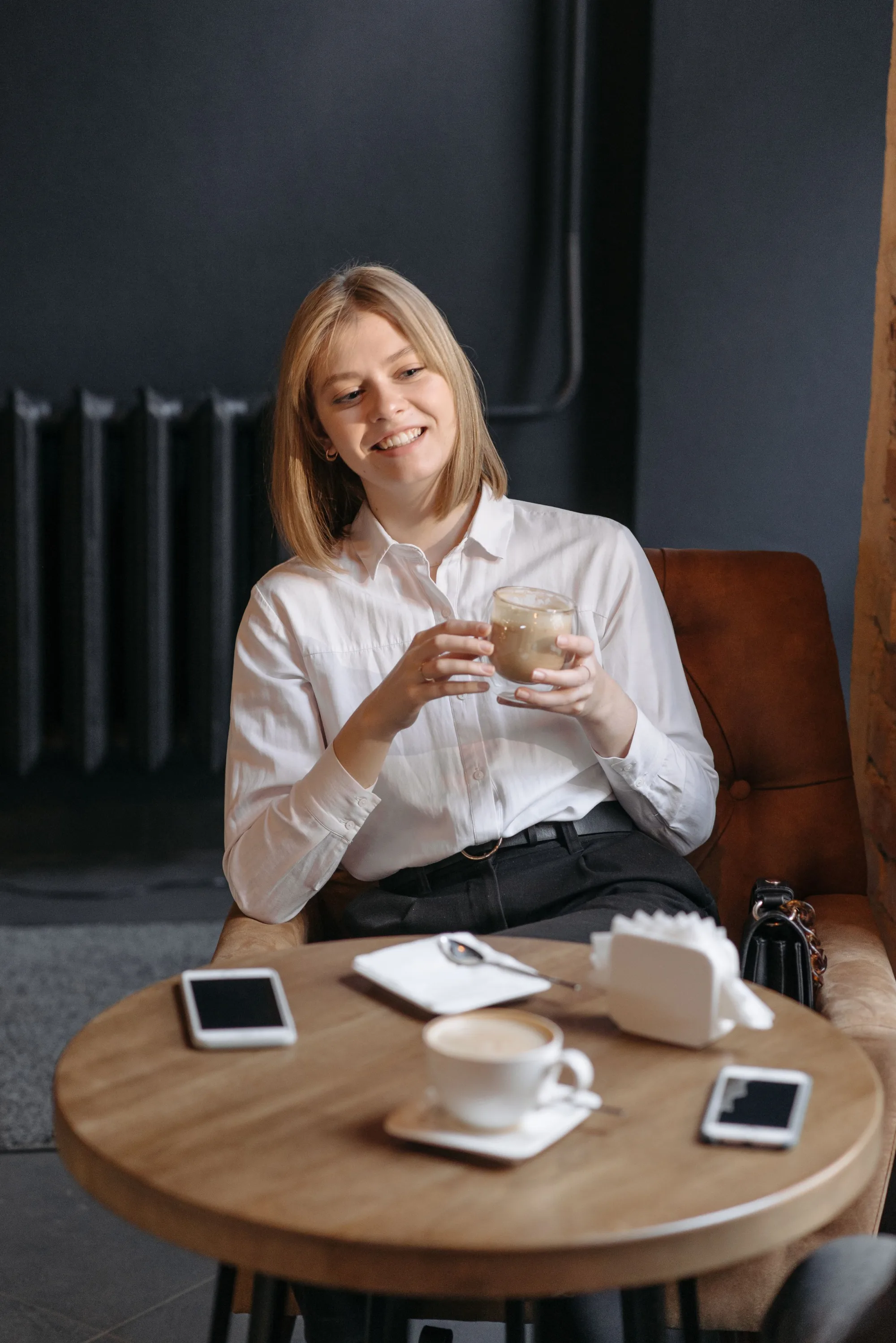 A smiling client enjoying a coffee